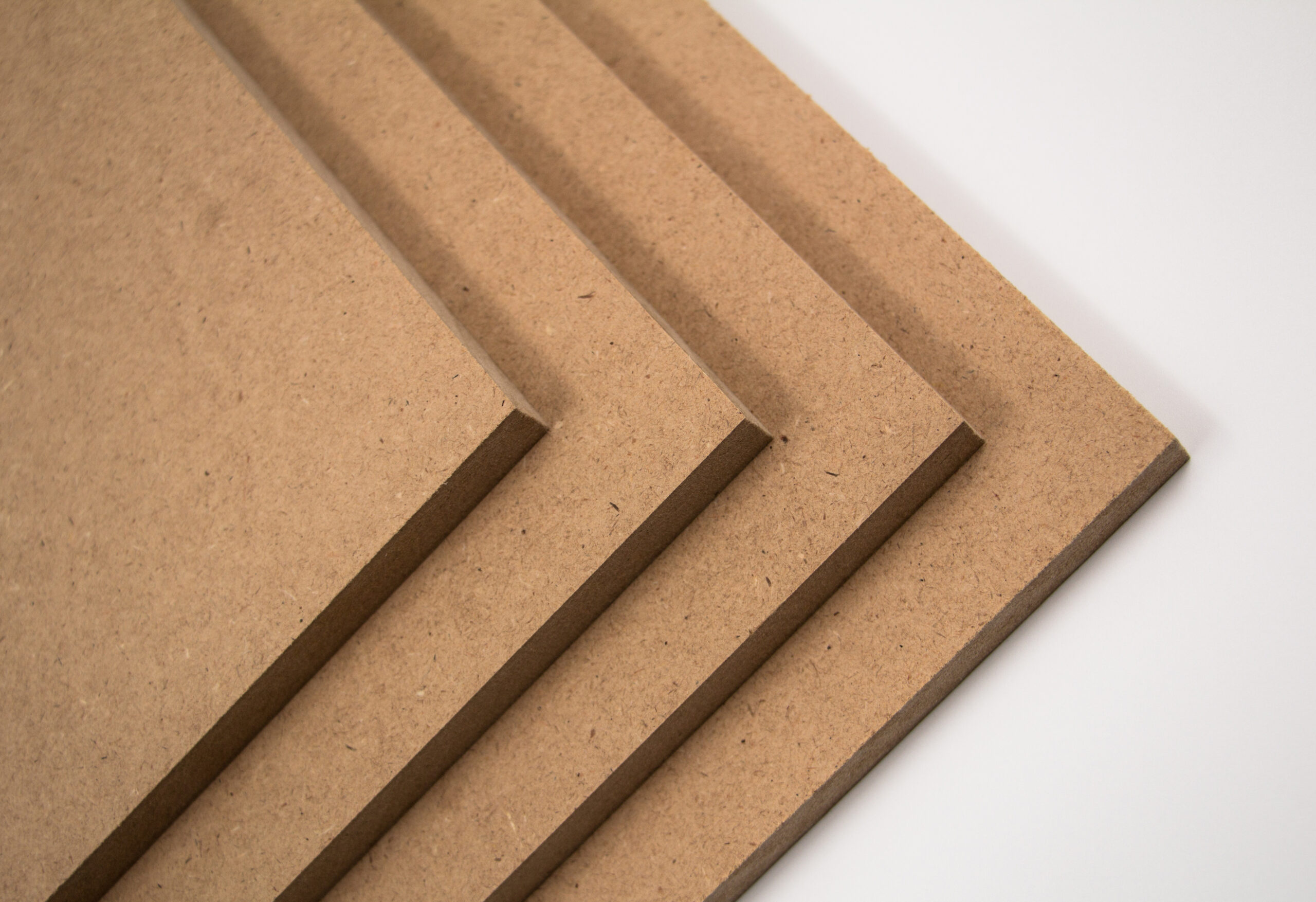 Raw MDF boards, brown in color. They are made of chopped wood.