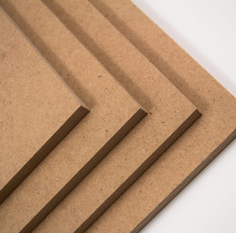 Raw MDF boards, brown in color. They are made of chopped wood.