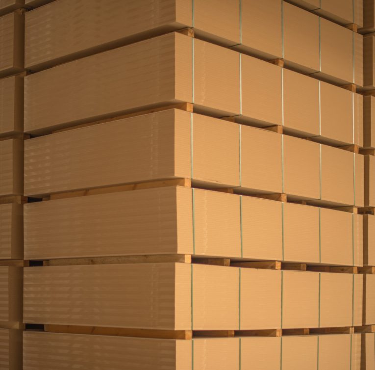 The stack of MDF boards tied with ribbon in stock.